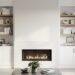 Modern living room showcasing a fireplace with white stone surround, flanked by white built-in cabinets and open oak shelves styled with books and decor; a sofa and coffee table sit softly out of focus in the background