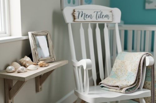 Cozy coastal-style nursery corner with a shelf of seashells, a driftwood-style frame, and a vintage quilt on a rocker near a crib.